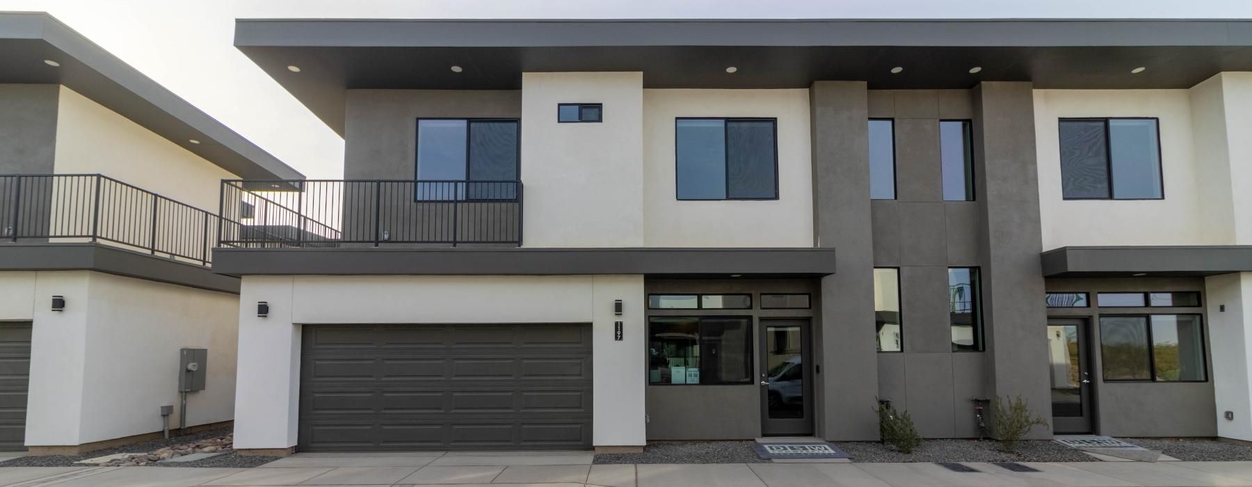 Settle into comfort at La Vida Rental Homes a grey and white building with a garage